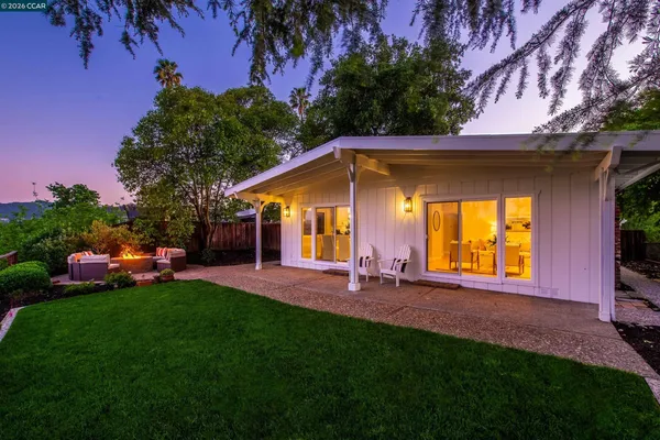 a view of a house with a yard porch and sitting area