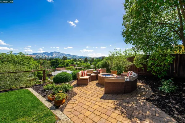 a view of a roof deck with couches and potted plants