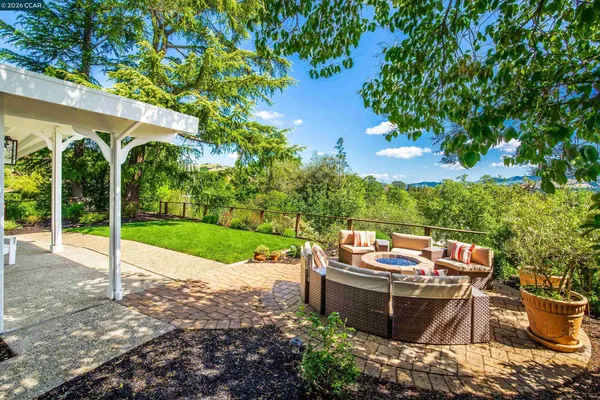 a view of a patio with couches chairs and a fire pit