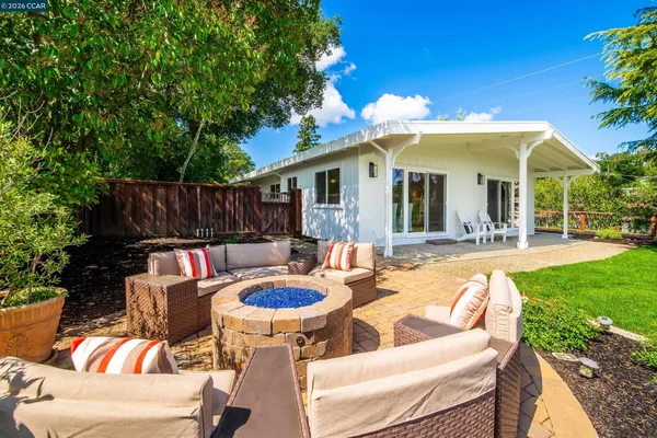 a view of a chairs and fire pit in the patio