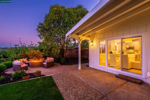 a backyard of a house with lots of green space and lake view