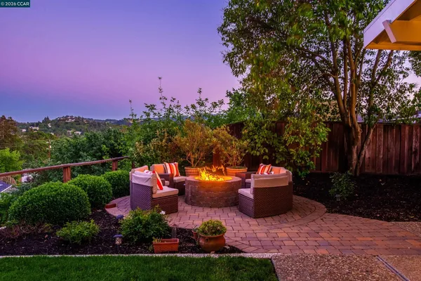 a view of a patio with couches and a fire pit