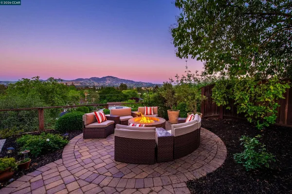 a view of a patio with a table and chairs