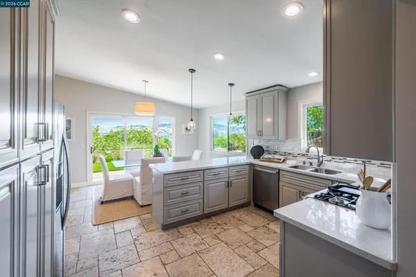 a large white kitchen with a large window