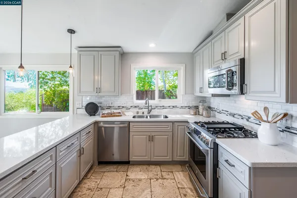 a kitchen with a sink stove and cabinets
