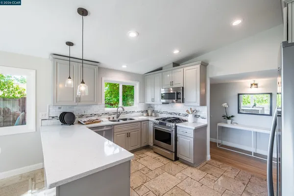 a kitchen with a sink stove and cabinets