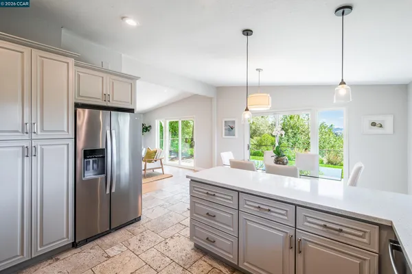 a kitchen with windows wooden floor and appliances