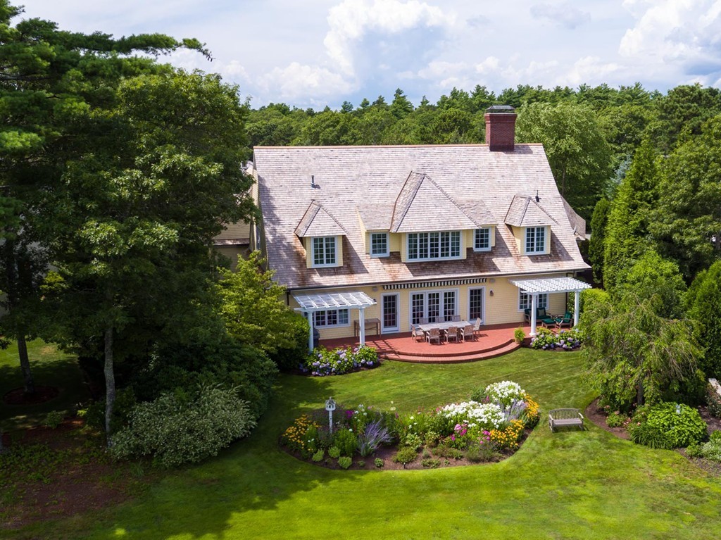 a aerial view of a house with a garden and trees