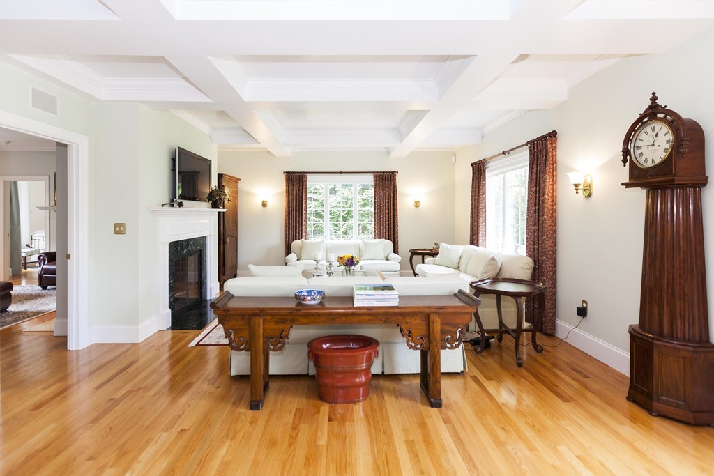 19 North Glen Drive Mashpee, MA 02649 - Photo 12 of 30 a view of a livingroom with furniture a fireplace a kitchen island space wooden floor and a window