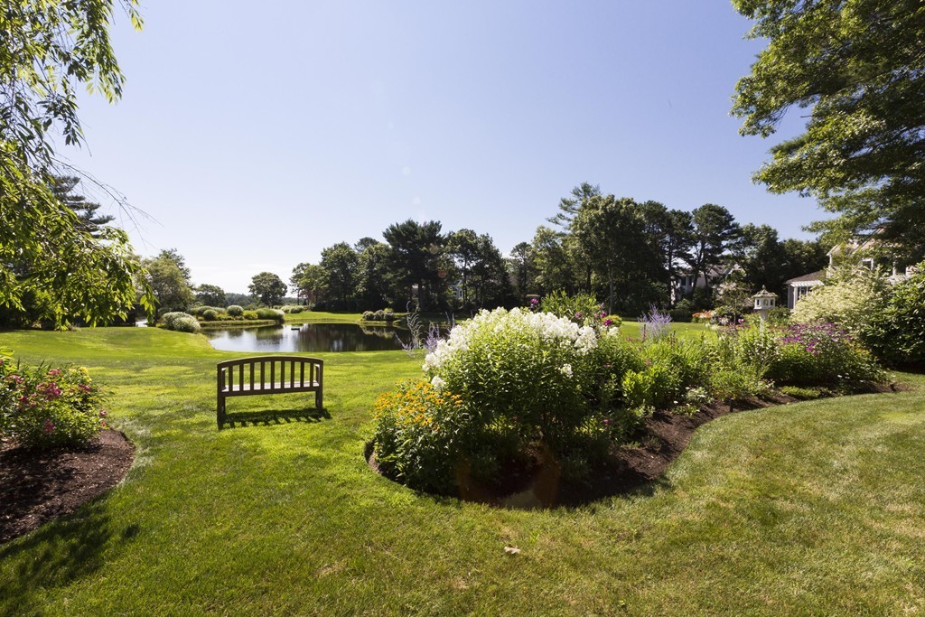 19 North Glen Drive Mashpee, MA 02649 - Photo 30 of 30 a view of a garden with a bench and trees