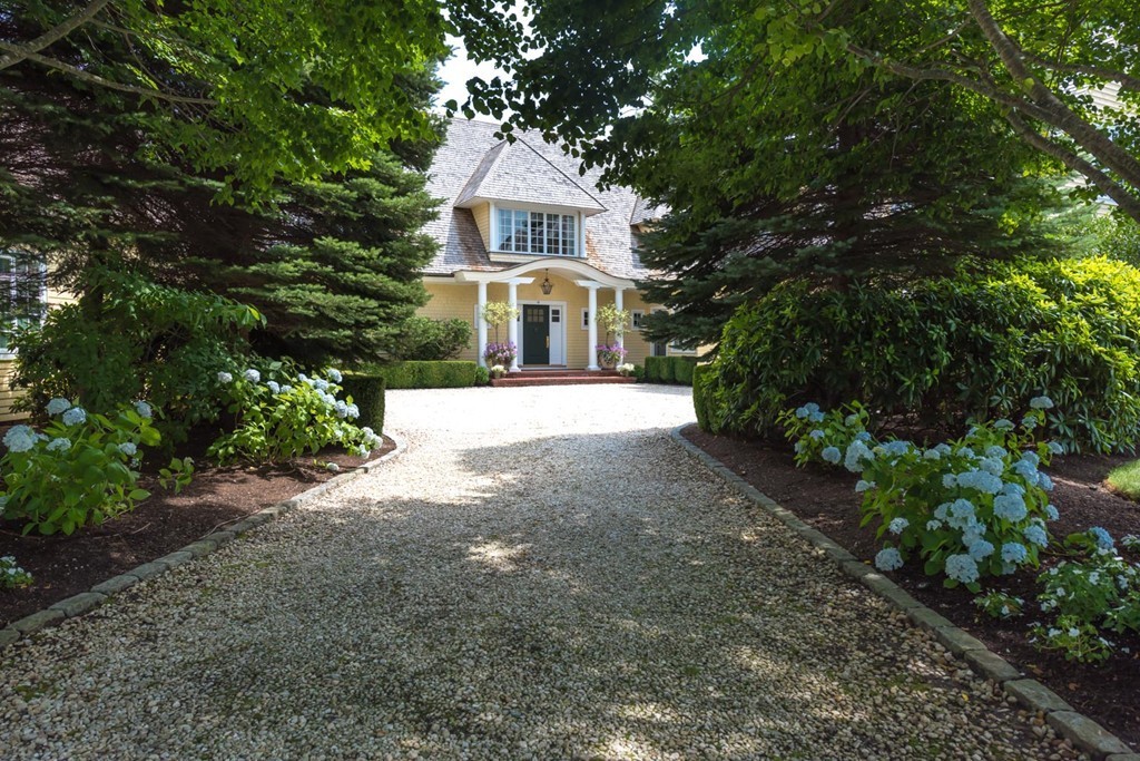 19 North Glen Drive Mashpee, MA 02649 - Photo 3 of 30 a front view of a house with a garden and trees