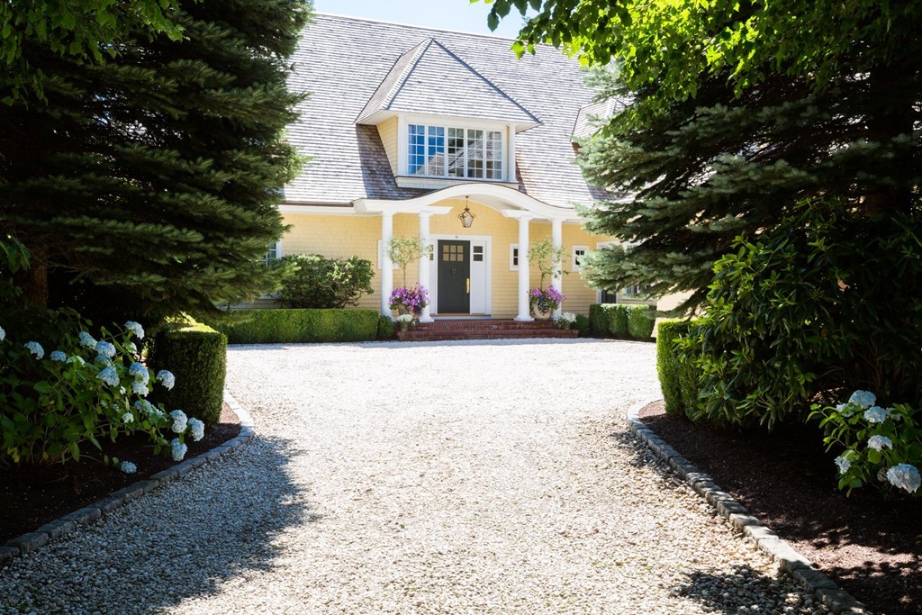 19 North Glen Drive Mashpee, MA 02649 - Photo 4 of 30 a view of a white house with a yard and potted plants