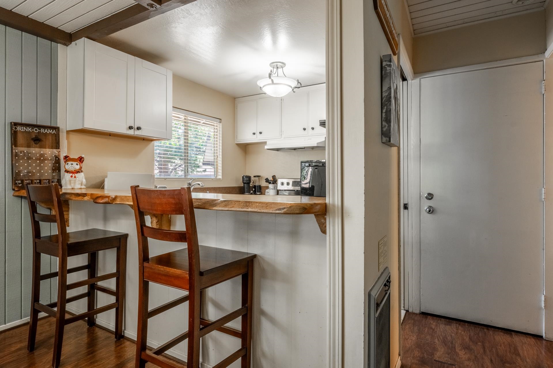 165 Old Mammoth Road, Unit 3 Mammoth Lakes, CA 93546 - Photo 11 of 48 Kitchenette featuring a live-edge wood countertop, white shaker cabinetry, and wood-finish flooring
