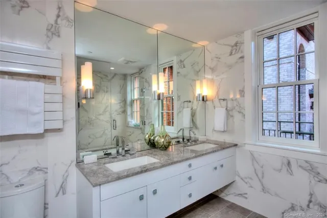 a bathroom with a granite countertop sink mirror and double