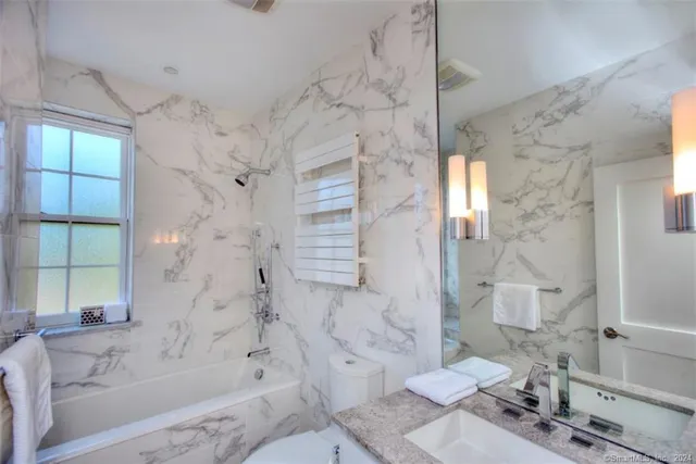 a bathroom with a sink toilet and shower