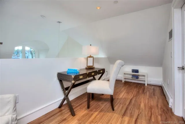 a view of brick house with wooden fence