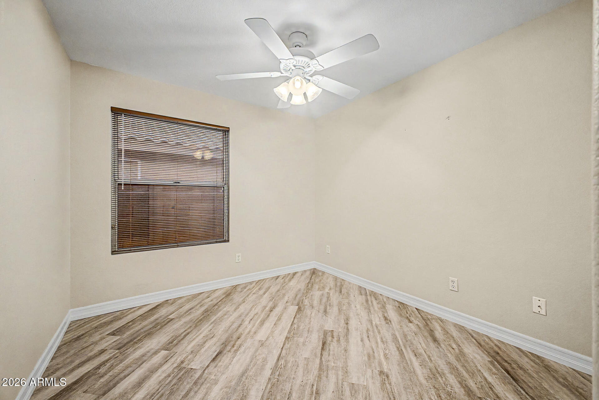 4102 East Rock Wren Road Phoenix, AZ 85044 - Photo 18 of 25 a view of an empty room with wooden floor and a window