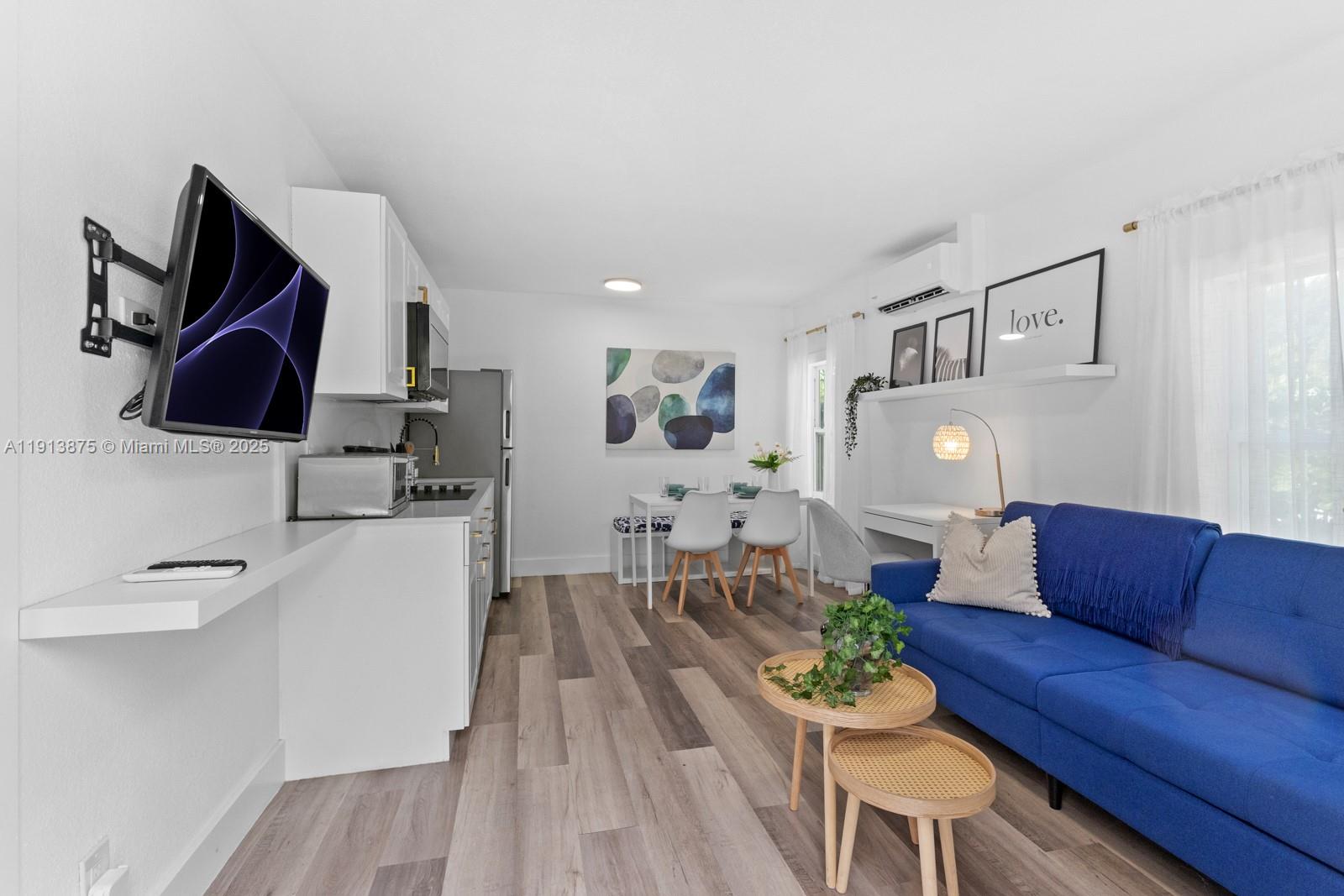 790 Northwest 60th Street Miami, FL 33127 - Photo 11 of 35 a living room with furniture and a flat screen tv