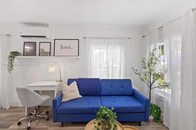 a living room with furniture and a potted plant