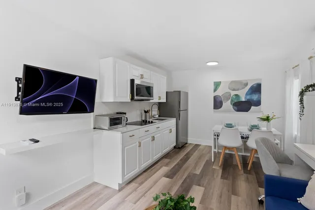 a kitchen with stainless steel appliances a stove a sink a microwave and cabinets