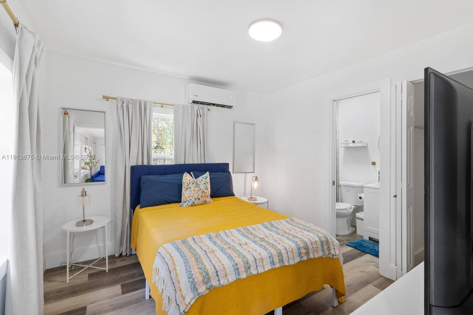 790 Northwest 60th Street Miami, FL 33127 - Photo 17 of 35 a bedroom with a bed and wooden floor