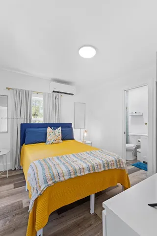 a bedroom with a bed and a table in it