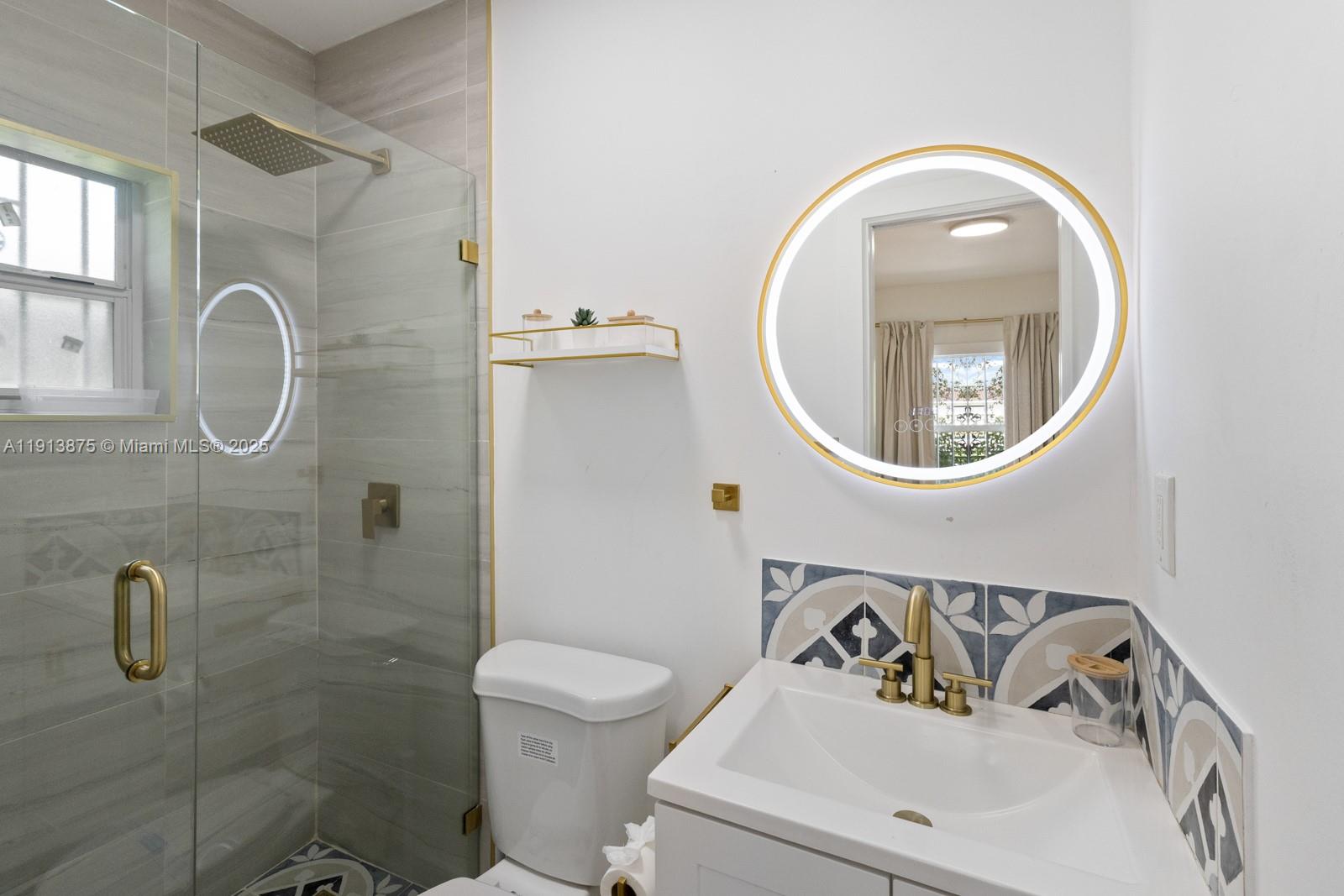 790 Northwest 60th Street Miami, FL 33127 - Photo 19 of 35 a bathroom with a sink mirror and toilet