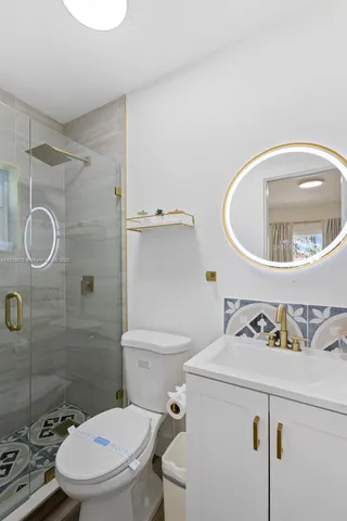 a white toilet sitting next to a bathroom sink