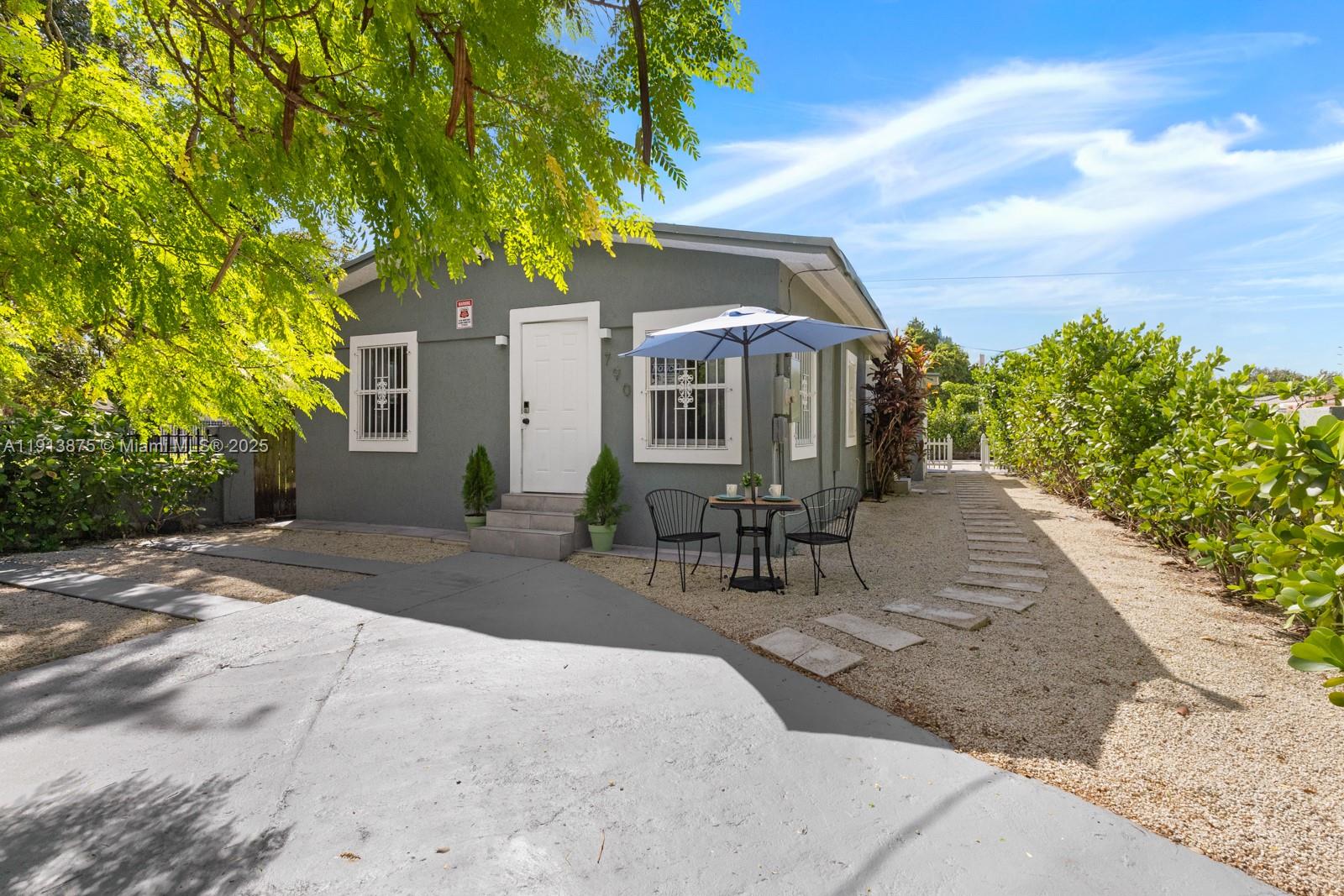 790 Northwest 60th Street Miami, FL 33127 - Photo 2 of 35 a front view of house with yard and seating space