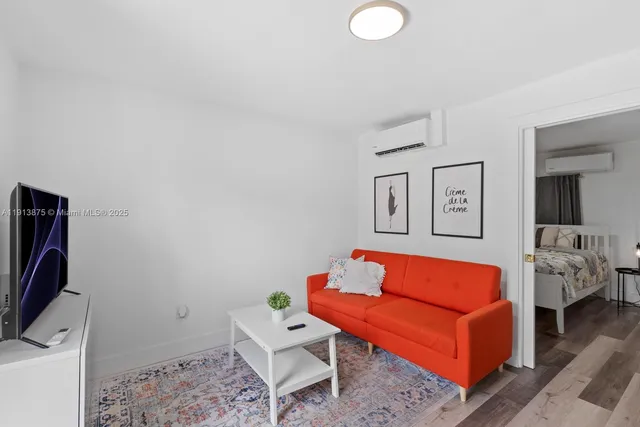 a living room with furniture and a flat screen tv