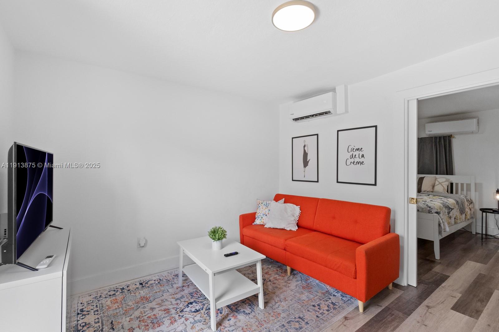 790 Northwest 60th Street Miami, FL 33127 - Photo 24 of 35 a living room with furniture and a flat screen tv