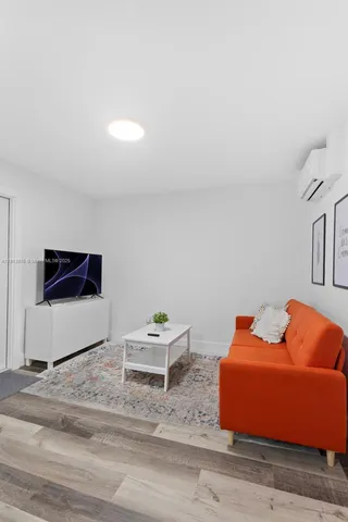 a bedroom with furniture and a flat screen tv