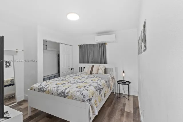 a bedroom with a bed and a table