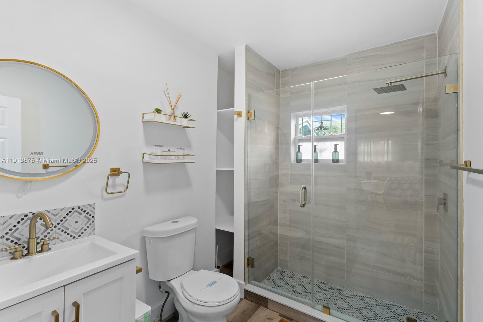 790 Northwest 60th Street Miami, FL 33127 - Photo 29 of 35 a white toilet sitting next to a bathroom sink