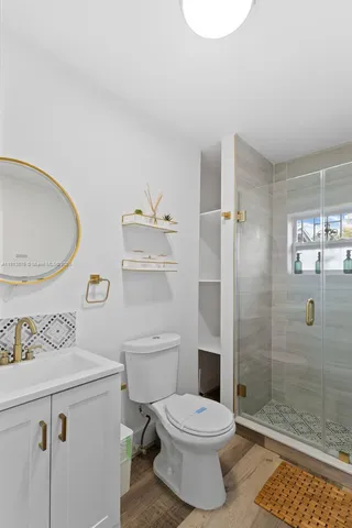 a bathroom with a toilet sink and shower