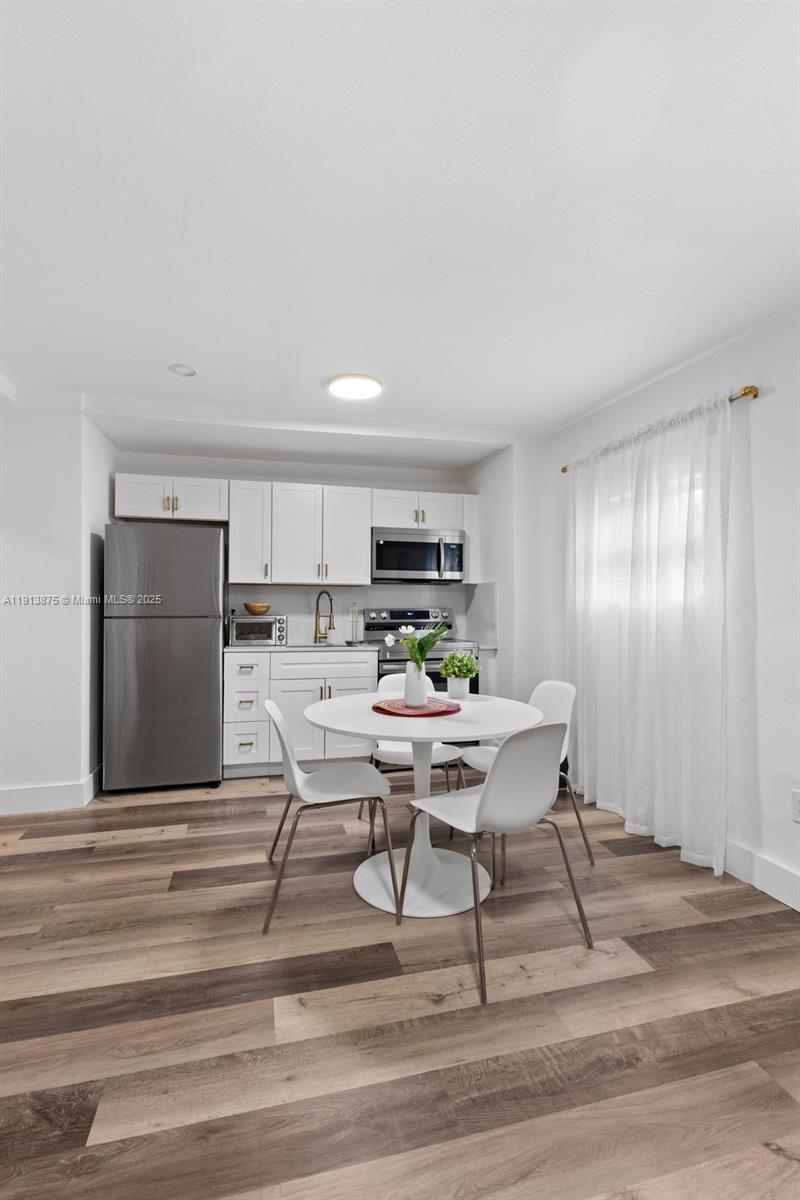 790 Northwest 60th Street Miami, FL 33127 - Photo 31 of 35 a workspace with furniture and a kitchen