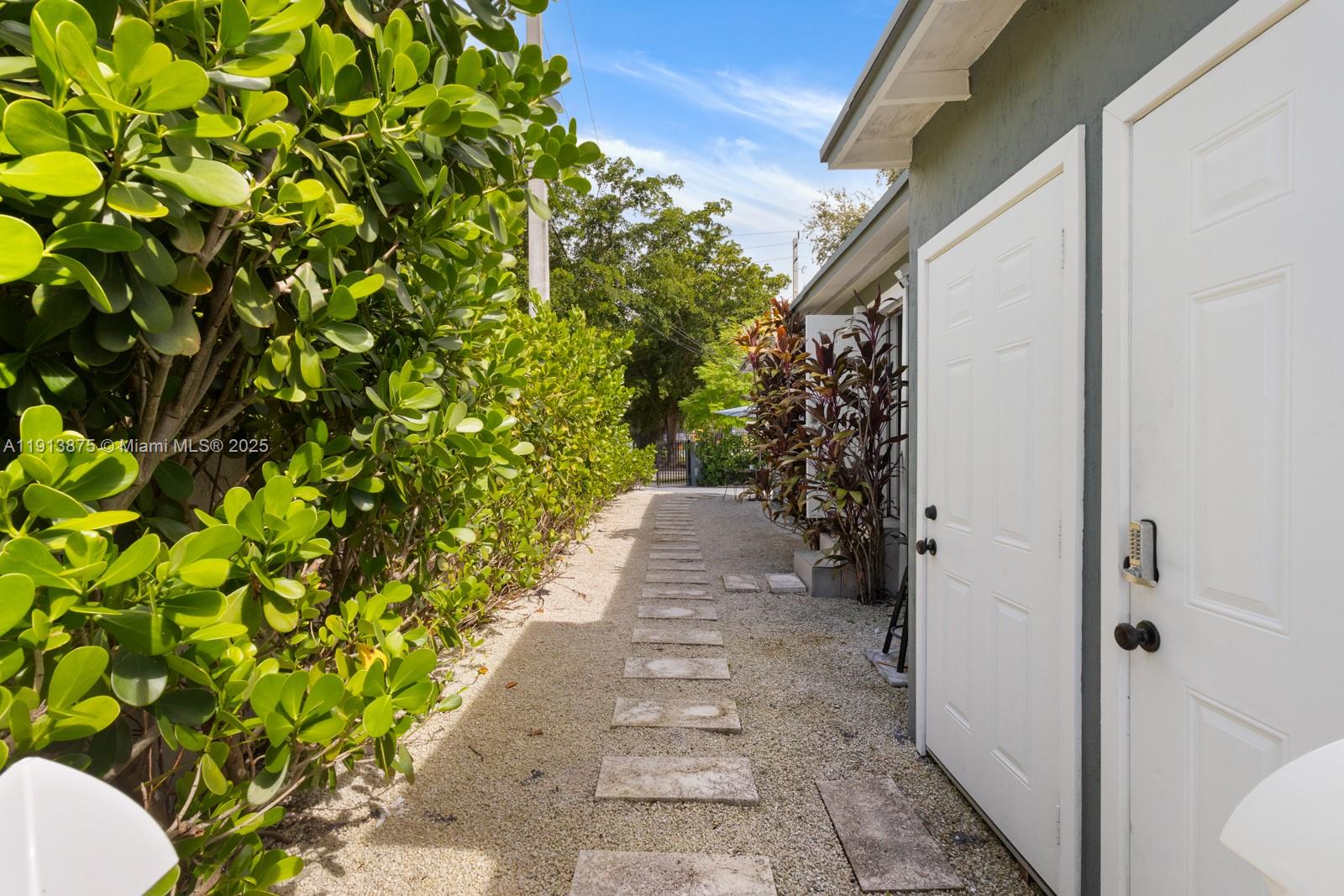 790 Northwest 60th Street Miami, FL 33127 - Photo 5 of 35 a view of a pathway besides a house