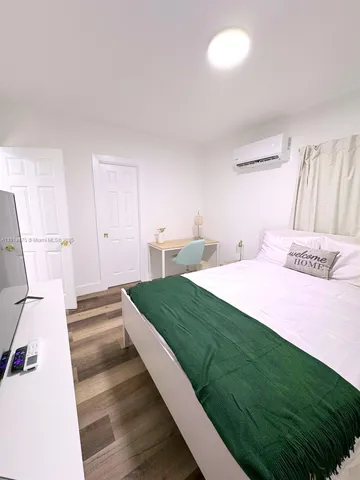 a bedroom with a bed and a walk in closet