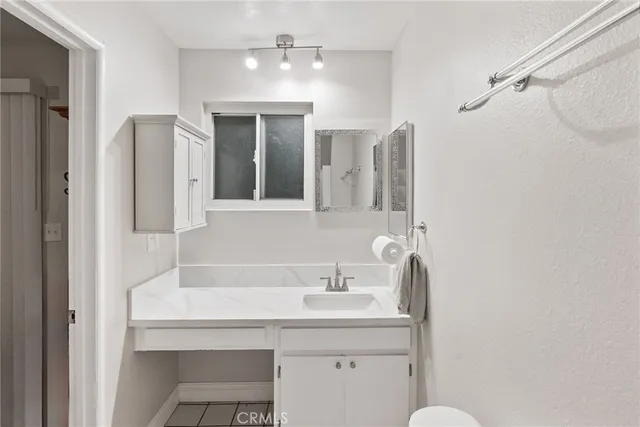 a view of a house with backyard sitting area and garden