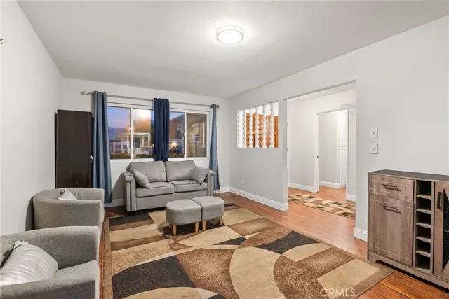 a view of a big yard with potted plants and large trees