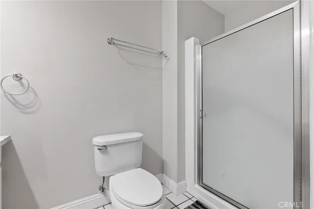 a view of a porch with chairs and potted plants