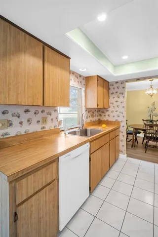 a kitchen with stainless steel appliances granite countertop a refrigerator sink and stove
