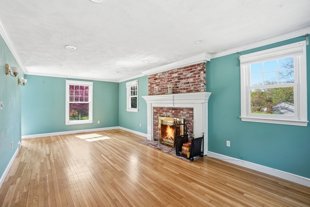 3 Fairway Drive Canton, MA 02021 - Photo 12 of 34 a view of an empty room with window wooden floor and a fireplace
