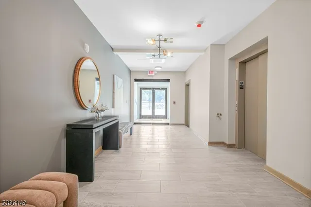 a living room with granite countertop furniture a sink a window and a mirror