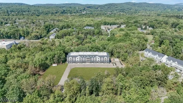 an aerial view of a house with yard and outdoor seating