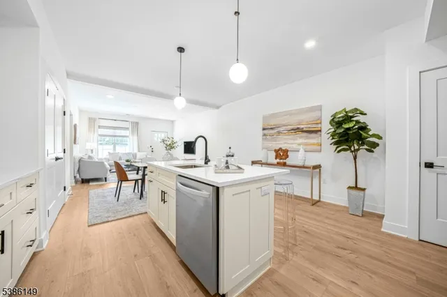 a open kitchen with stainless steel appliances granite countertop a white cabinets stove and refrigerator