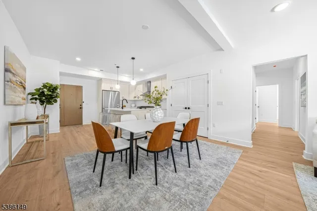 a view of a dining room with furniture and wooden floor