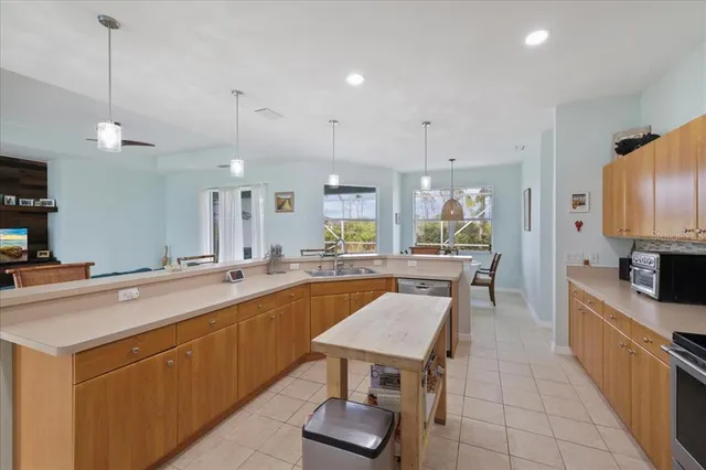 a kitchen with stainless steel appliances a refrigerator sink and stove
