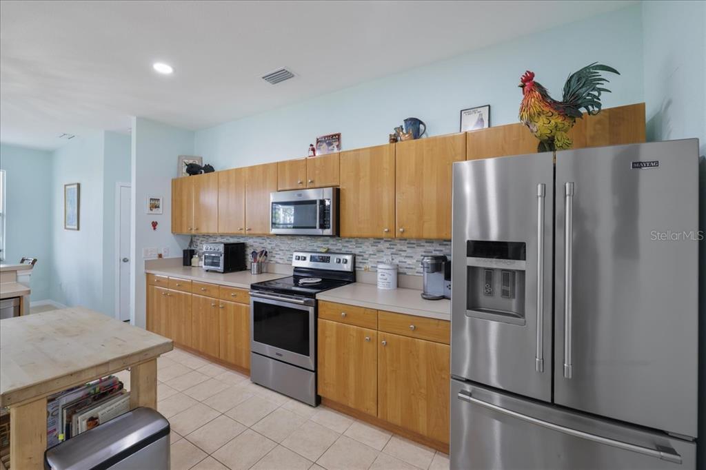 8 Abaft Place Placida, FL 33946 - Photo 12 of 45 a kitchen with stainless steel appliances a refrigerator sink and stove