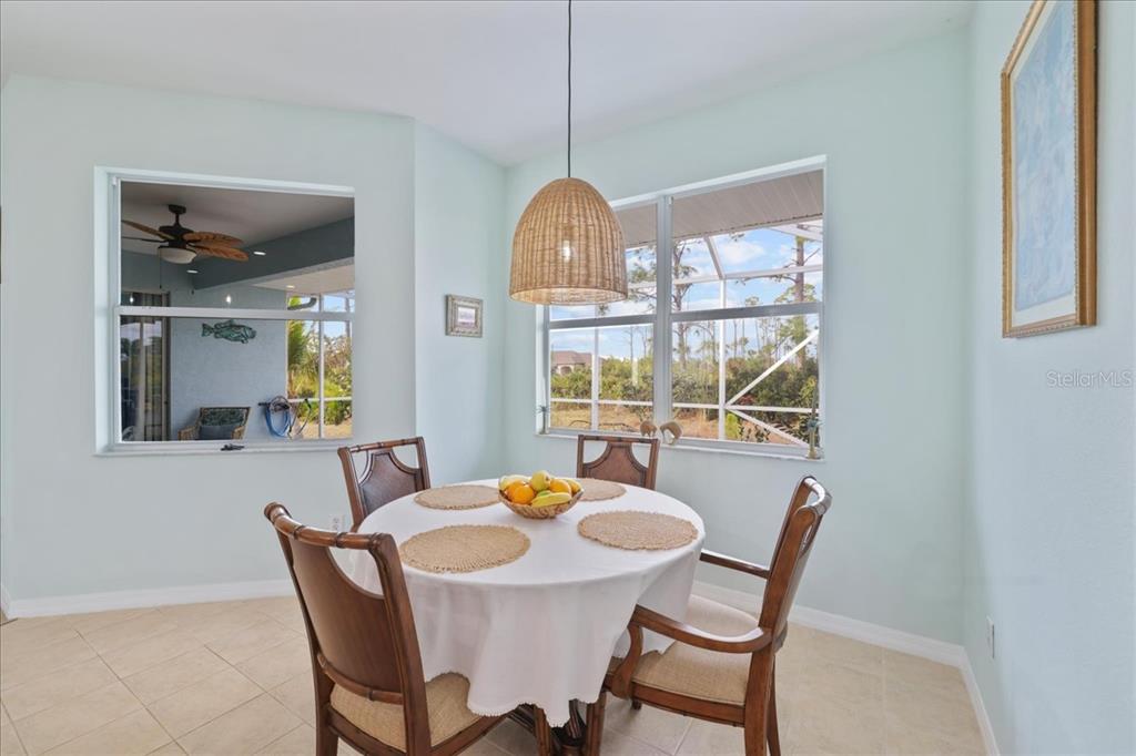8 Abaft Place Placida, FL 33946 - Photo 14 of 45 a dining room with furniture a chandelier and wooden floor